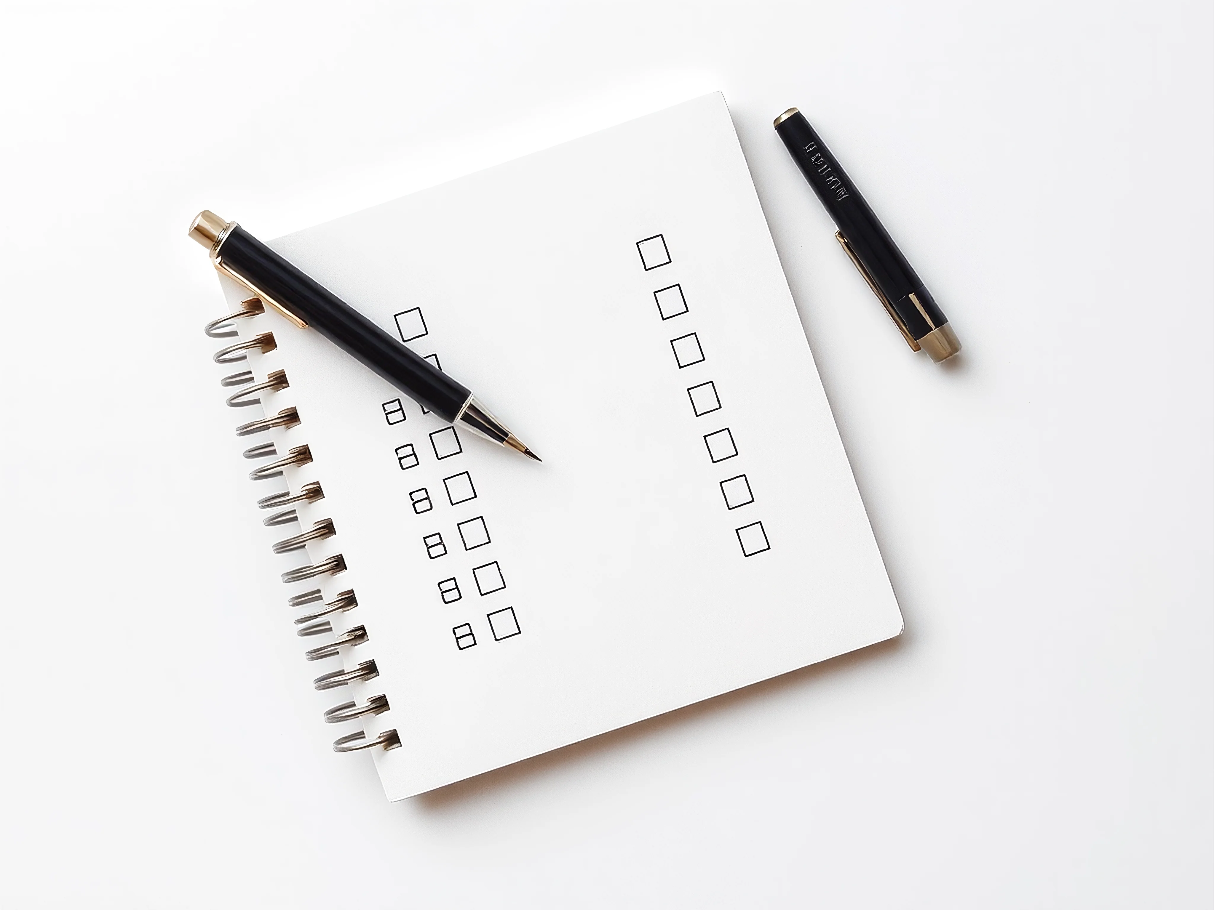 Top-down view of a multiple-choice assessment on a notepad with a pen on a white background.